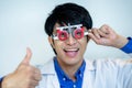 Happy man checking vision with eye test glasses during a medical examination at the ophthalmological office, Checking eye vision Royalty Free Stock Photo