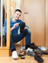 Happy man cleaning shoes