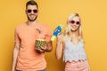 Happy man with cocktail in pineapple and cheerful blonde girl with water gun Royalty Free Stock Photo