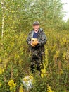 The happy man costs with mushrooms in hands focus on mushrooms