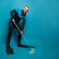 Happy man diver with mop on blue banner background. Clean and environmental protection concept Royalty Free Stock Photo