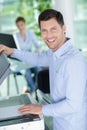 Happy man doing documents copies on copying machine Royalty Free Stock Photo
