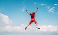 Happy man dressed red jumping over the clouds with Annapurna range mountains on background as he had trekking to Shanti Peace Royalty Free Stock Photo