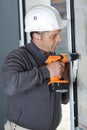 happy man drilling wall with drill perforator Royalty Free Stock Photo