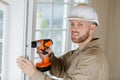 Happy man drilling wall with drill perforator Royalty Free Stock Photo