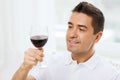 Happy man drinking red wine from glass at home Royalty Free Stock Photo