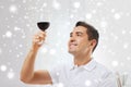 Happy man drinking red wine from glass at home Royalty Free Stock Photo