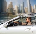 Happy man driving cabriolet car on city Royalty Free Stock Photo