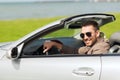 Happy man driving cabriolet car outdoors Royalty Free Stock Photo