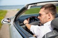 Happy man driving cabriolet car outdoors Royalty Free Stock Photo