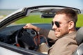 Happy man driving cabriolet car outdoors Royalty Free Stock Photo