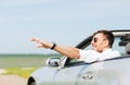 Happy man driving cabriolet car and waving hand Royalty Free Stock Photo