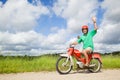 Happy man driving a moped Royalty Free Stock Photo
