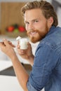 Happy man eating yogurt at home Royalty Free Stock Photo
