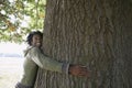 Happy Man Embracing Tree Trunk At Park Royalty Free Stock Photo