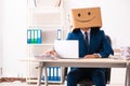 Happy man employee with box instead of his head