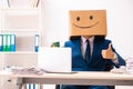 The happy man employee with box instead of his head