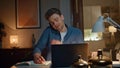 Happy man enjoy call noticing notebook at evening apartment closeup. Guy talking