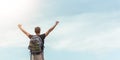 Happy man enjoying freedom and standing with open arms over sky and cloud, Carefree Traveler with backpack relaxing and raised