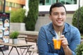 Happy man enjoying a juice outdoors Royalty Free Stock Photo