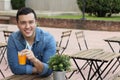 Happy man enjoying a juice outdoors Royalty Free Stock Photo