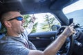 Happy man enjoying a road trip in his car on a sunny day Royalty Free Stock Photo