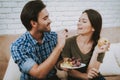 Happy Man Feeding Fruits Woman with Apple in Hand.