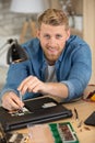happy man fixing computer laptop tr Royalty Free Stock Photo