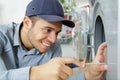 Happy man fixing washing machine Royalty Free Stock Photo