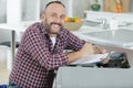 happy man fixing washing machine Royalty Free Stock Photo