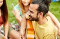 Happy man with friends playing guitar at camping Royalty Free Stock Photo