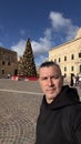 Happy man in front of the Christmas tree, Valletta, Malta Royalty Free Stock Photo