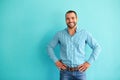 Happy man in front of turquoise wall