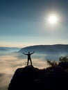 Happy man gesture raised arms. Funny hiker with raised hands