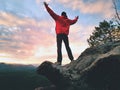 Happy man gesture of triumph with rams in air. Funny hiker on peak of rock Royalty Free Stock Photo