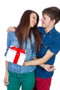 Happy Man giving a gift to his Girlfriend. Happy Young beautiful Couple isolated on a White background. Royalty Free Stock Photo