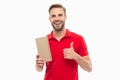 Happy man giving thumbs-up holding cardboard box. Delivery man isolated on white. Package delivery Royalty Free Stock Photo