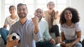 Happy man in glasses watching football match, celebrating goal Royalty Free Stock Photo