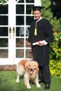 Happy man graduated holding and showing degree with his dog, idea for education concept Royalty Free Stock Photo