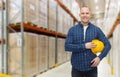 Happy man with hardhat over warehouse