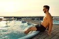 Happy man having fun near outdoor swimming pool on summer day Royalty Free Stock Photo