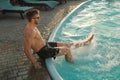 Happy man having fun near outdoor swimming pool on summer day Royalty Free Stock Photo