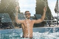 Happy man having fun in outdoor swimming pool on sunny summer day Royalty Free Stock Photo