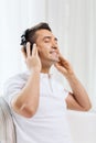 Happy man in headphones listening to music at home Royalty Free Stock Photo