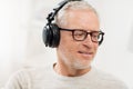 Happy man in headphones listening to music at home Royalty Free Stock Photo