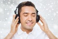 Happy man in headphones listening to music at home Royalty Free Stock Photo