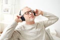 Happy man in headphones listening to music at home Royalty Free Stock Photo