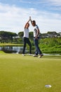 Happy man, high five and celebration with hole on golf course for winning, point or score in nature. Male person Royalty Free Stock Photo