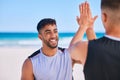 Happy man, high five and teamwork in fitness on beach for workout success, training or outdoor exercise. Excited male Royalty Free Stock Photo