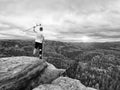 Happy man hiker holding medicine crutch above head, injured knee fixed in knee brace feature